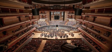 Symphony orchestra and choir performing Romany Wood on stage at Birmingham Symphony Hall