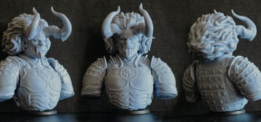 three different sized statues of a man with horns and horns
