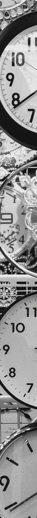 a bunch of clocks on a wall with many different clocks