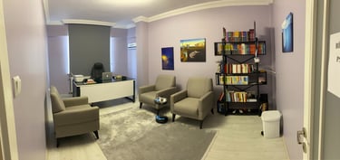 a living room with a chair and a desk