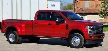 a red  ford truck parked in lot after being detailed ceramic coating