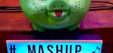 A green pig bank with a light sign with a written saying Mashup Band Brazil.