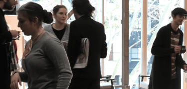a group of people standing around a table
