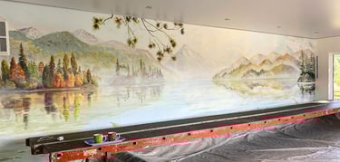 Painted panorama lake mural in progress with scaffold, showing New Zealand mountains and water view.