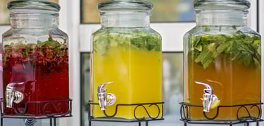 three jars of drinks in a row of three different colors