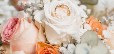 a bouquet of flowers with a wedding ring