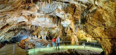 Visitors on illuminated bridge in Lipa Cave near Cetinje Montenegro