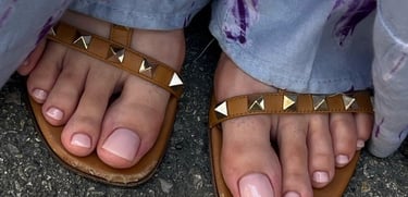 a person wearing sandals and a pair of sandals