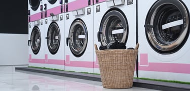 Commercial washing machines with a basket placed on top, showcasing industrial laundry equipment for heavy-duty use 1