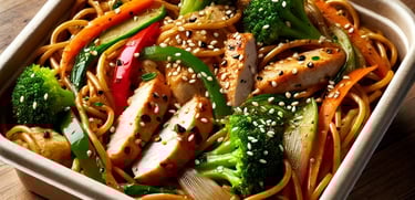 a bowl of noodles with chicken and vegetables