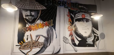 Animated images of the head chefs painted on the wall of a restaurant.