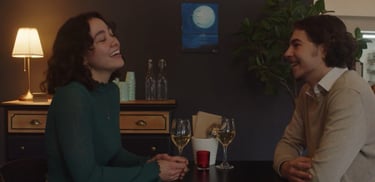 a man and woman sitting at a table