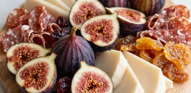 A cozy setup featuring a grazing board paired with a cup of coffee, highlighting the coffee color text theme.