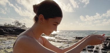 Girl at beach holding water