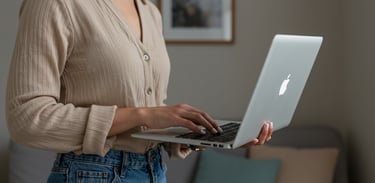 female business coach typing on Apple laptop