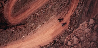 a person riding a bike on a dirt road