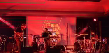 a band playing music on stage at a concert