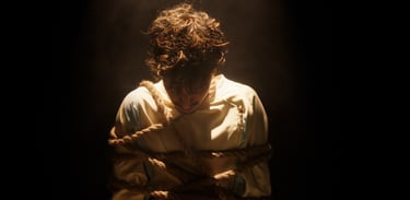 a man in a white shirt is tied up and tied up