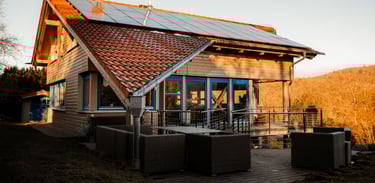 Südfassade mit Blick auf Terrasse, Photovoltaik und abgeschlepptem Dach