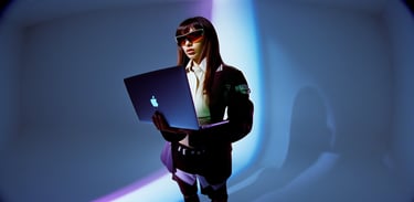 a woman in a suit and sunglasses holding a laptop