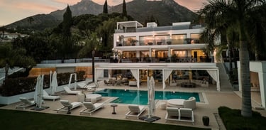 Sunset view of Villa Serenity exterior with pool and gardens