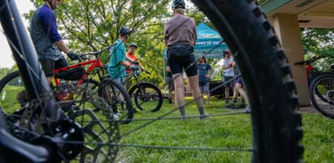 People on bikes in the background of a photo with the focus on a bike tire