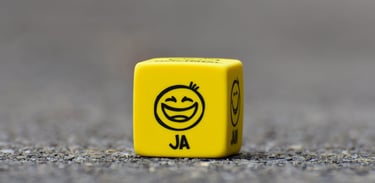 a yellow dice game dicer with a smiley face