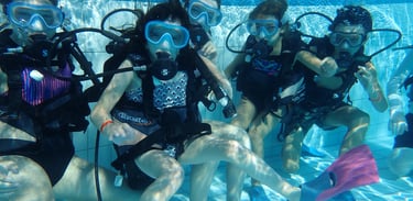 a group of scuba divers in a pool