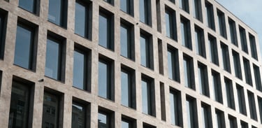 Architectural photography of a contemporary office building in Denmark, emphasizing structure, security, and professional stability.