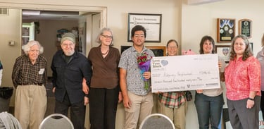 Everyone who was awarded a grant posing for a photo with a large check