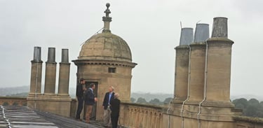 The directors of Byrga Geniht being shown the roof of Wollaton Hall.