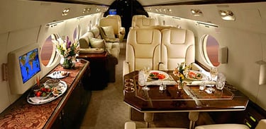 Luxury private jet cabin featuring elegant dining, plush leather seating, and premium in-flight service. Designed for elite t