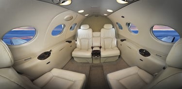 Luxury private jet interior with plush leather seating and panoramic windows, offering premium comfort for VIP travelers and 