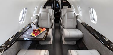 Luxury private jet interior featuring plush leather seats, premium in-flight dining, and VIP comfort. Ideal for business exec