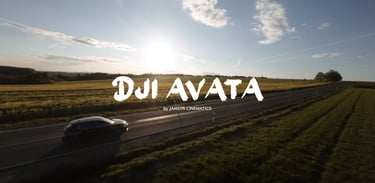 a car driving down a country road with the sun setting behind