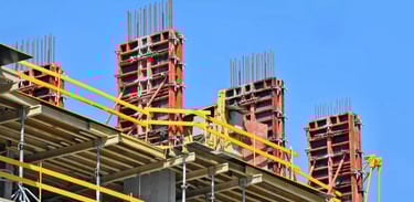 a building with a lot of construction materials and a blue sky