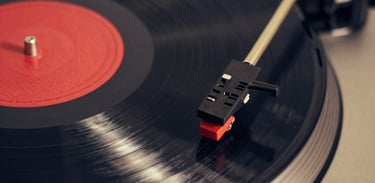 A vibrant vinyl record spinning under colorful party lights, capturing the energy of outsider music.