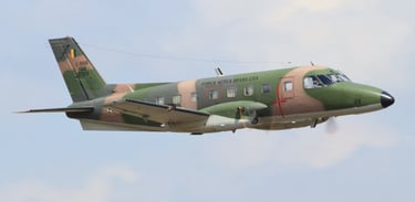 a military plane flying in the sky, embraer 110 emb-110