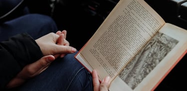 two people holding hans and readning a book