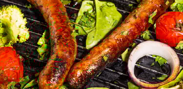Sustainable plant-based, nutritionally-dense, hypoallergenic protein and fibre sausages with vegetables surrounding