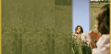 Woman gazing into mirror in meadow, symbolizing inner alignment, reflection, and self-leadership
