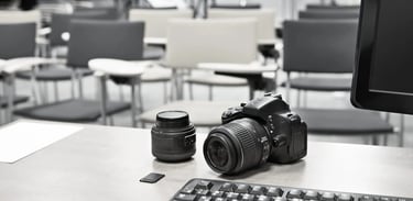 Art Photography Academy classroom setup with camera gear and learning materials.