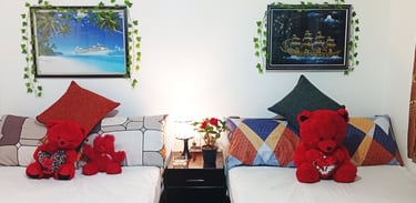 Family room at Nobel Bungalow Nuwara Eliya with wall art, soft lighting, and red teddy bears