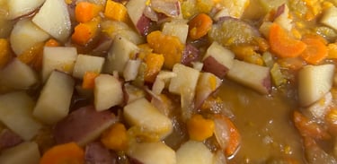 Vegetable soup with a blend of potatoes, sweet potatoes, carrots, celery and broth shown.