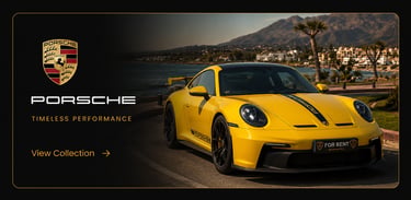 Yellow Porsche 911 GT3 luxury car for rent parked on a scenic coastal road at sunset.