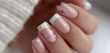 Sheer nude nails with delicate floral nail art and French tips