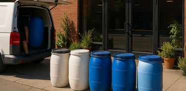 Barrels with used malt being picked up by a ban in front of the entrance of a brewery