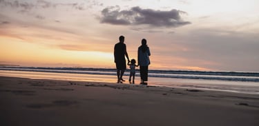 family walking at sunset during photography session at Kuta Beach Bali
