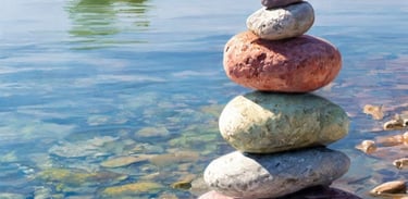 a stack of rocks sitting on top of a river