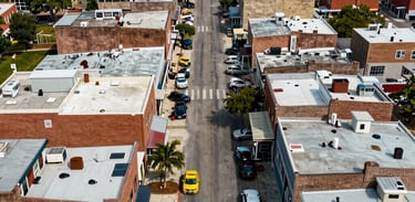 An aerial view of a vibrant small business corridor in a revitalized North American urban district, symbolizing economic empowerment.